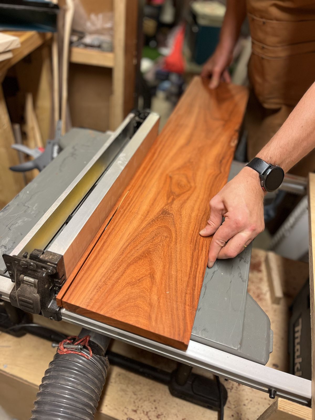 Padouk board positioned on the table saw, ready to be cut
