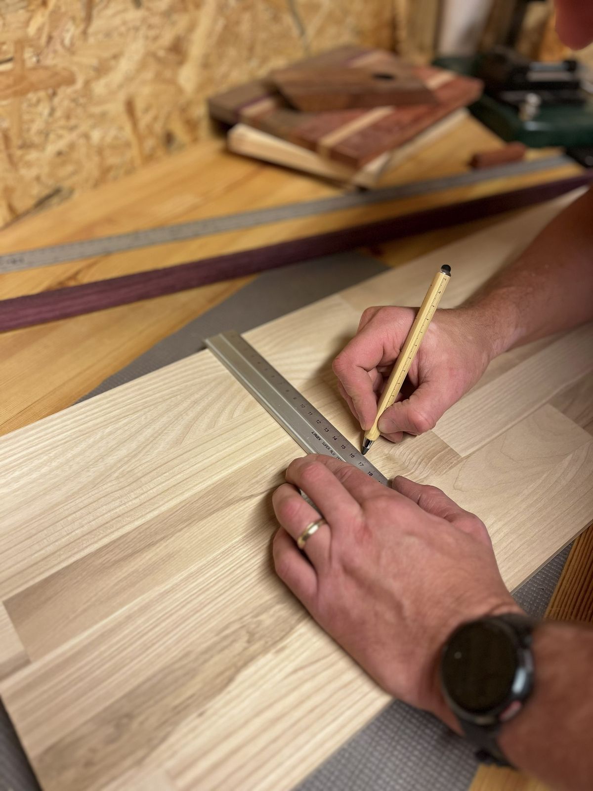 Marking precise measurements on a wood board with a ruler and pencil