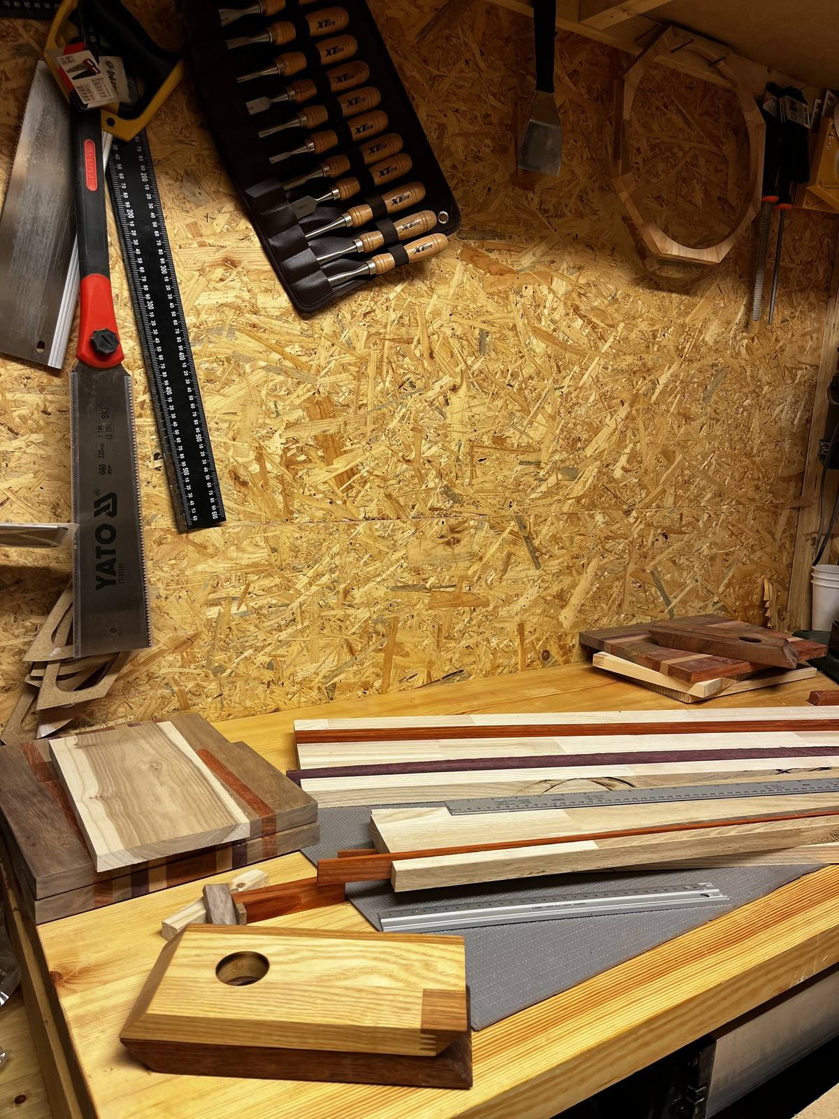 Woodworking tools and assorted wood strip samples in the workshop